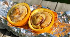 two peeled oranges sitting on top of aluminum foil