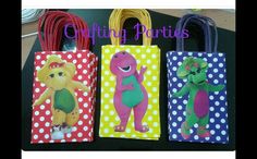 three bags with cartoon characters on them sitting on a table next to some paper straws