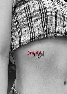 a woman's stomach with the word angel tattooed on her left side ribcage