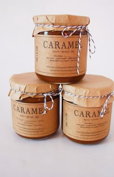 three jars of caramel sitting on top of each other