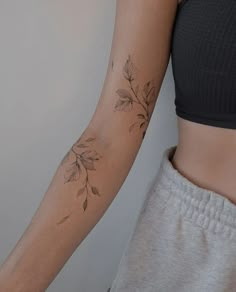 a woman's arm with a flower tattoo on the left side of her body