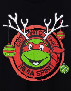 a t - shirt that says get into the ninja spirit with some ornaments hanging from it