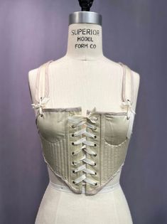 Introducing Sportstays - the perfect addition to your historical costume! Combining the classic look of a corset with the flexibility and comfort of a sports bra, SportStays lets you step into the past without sacrificing modern comfort. Our easy front lacing design ensures you'll never need a friend to tighten your corset again. Whether you're attending a historical reenactment, a Renaissance fair, or simply embracing vintage style, SportStays offers both elegance and ease. SportStays: Where timeless style meets modern comfort. Fitted Underbust Bodice With Built-in Bra, Beige Corset With Built-in Bra For Spring, Spring Beige Corset With Built-in Bra, Beige Sleeveless Corset With Built-in Bra, Spring Stretch Corset With Boned Bodice, Spring Stretch Overbust Corset, Spring Overbust Stretch Corset, Underbust Bodice With Built-in Bra, Stretch Underbust Corset Bra-friendly