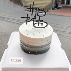 a birthday cake sitting on top of a white box