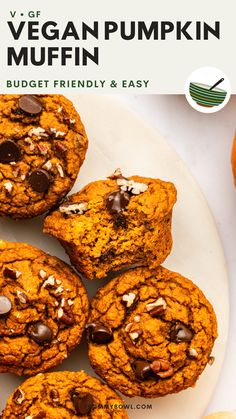 a white plate topped with chocolate chip cookies and muffins next to an orange