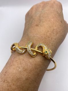 Vintage snake bangle bracelet   9k gold filled  Adjusts to  fits a small to average wrist    All jewelry is shipped free in the US in a nice gift box.   Check out our over a THOUSAND great reviews Engraving is $4 per letter and is not always perfect depending on the piece. It can take a few days if the jeweler is busy. This is payable to Paypal Judithsltd@gmail.com Snake Bangle Bracelet, Adjustable Gold Snake-shaped Jewelry, Flexible Gold Cuff Bracelet As Gift, Elegant Snake-shaped Bangle For Gift, Elegant Snake-shaped Bangle As Gift, Flexible Gold-plated Bangle As Gift, Flexible Yellow Gold Cuff Bracelet Gift, Elegant Snake Shape Bangle Gift, Elegant Snake Shape Bangle Perfect For Gift