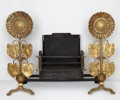 an old fashioned typewriter with three sunflowers on it's legs and two other decorative objects