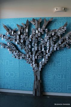 a tree made out of wooden blocks in front of a blue wall