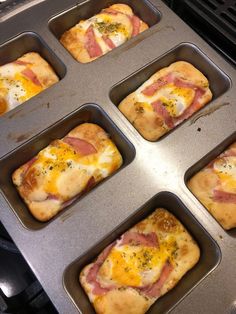 six muffins with ham and cheese in a pan on top of an oven