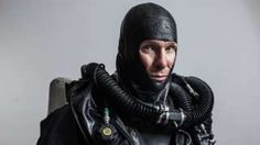 a man wearing a scuba suit and diving mask