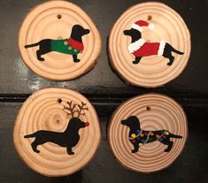 four wooden ornaments with dogs painted on them