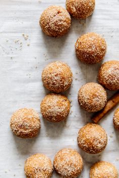 some sugared donuts and cinnamon sticks on a table