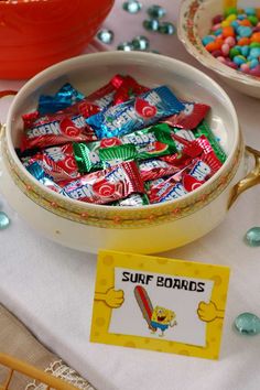 a bowl filled with candy sitting on top of a table