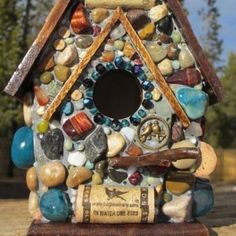 a bird house made out of rocks and stones