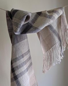 a plaid scarf hanging on a clothes line