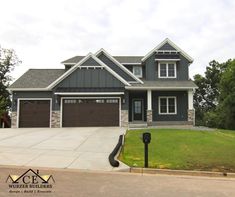 a large gray house with two garages on the front