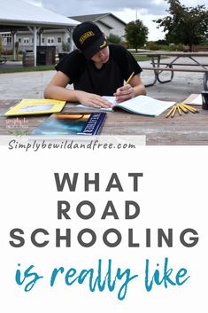 a man sitting at a picnic table writing in a book with the words what road schooling is really like