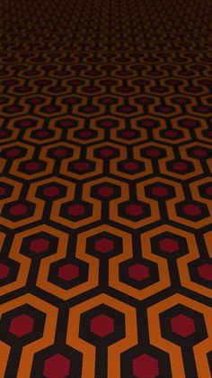 an orange and black carpet with red hexagons in the center on it