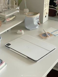 an apple laptop computer sitting on top of a white desk