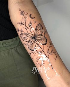 a woman's arm with a butterfly and flower tattoo on the left side of her arm