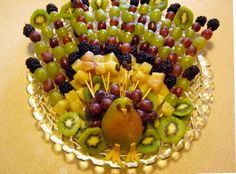 a bowl filled with lots of fruit on top of a table