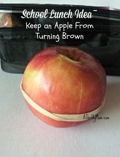 an apple sitting on top of a white table next to a black bag with the words school lunch idea keep an apple from turning brown