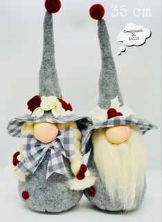 two gnomes with hats and bows are standing next to each other