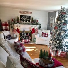 a living room decorated for christmas with red and white decorations