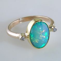 Fine Jewelry Oval Cabochon Opal Ring, Oval Cabochon Opal Ring Fine Jewelry, Oval Cabochon Opal Ring In Fine Jewelry, Oval Ethiopian Opal Anniversary Jewelry, Fine Jewelry Oval Opal Ring With Polished Finish, Oval Opal Ring With Polished Finish In Fine Jewelry, Green Oval Opal Ring, Oval Opal Ring With Polished Finish, Elegant Oval Opal Ring With Gemstone Accents