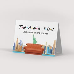 a thank card with an image of the statue of liberty on top of a couch