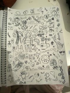 an open notebook with drawings on it