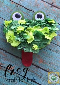 a paper plate with leaves and googly eyes on it, sitting on a wooden surface