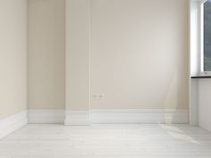 an empty room with a window and white tile floor in front of the wall,