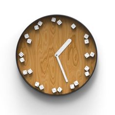 a wooden clock with white cubes on it's face and numbers in the middle