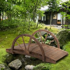 a wooden bridge in the middle of a lush green forest with a rainbow colored background