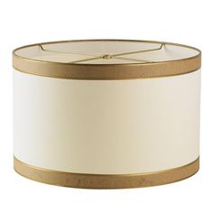 a white lamp shade with gold trim around it