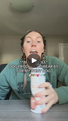 a woman sitting at a table with a cup in front of her mouth and the caption dog product is swear by for my tighty dog