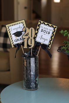 graduation decorations in a vase on a table