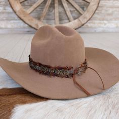 The Brazons Western Feather Hat Band, with its 3 cm width and approximately 58 cm length (excluding leather ties), offers a blend of rugged style and sophisticated detailing. Crafted to fit most, this band is easily adjustable with leather ties, ensuring a secure fit and a touch of personalized flair. Perfect for those who appreciate the subtle elegance of western-inspired accessories, this feather-adorned hat band adds a distinctive edge to any hat. Leather Cowboy Hat Bands, Feather Hat Band, Cowboy Hat Bands, Leather Cowboy Hats, Hat Bands, Feather Hat, Rugged Style, Subtle Elegance, Pets For Sale