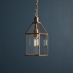 a light fixture hanging from a chain in a room with blue walls and flooring