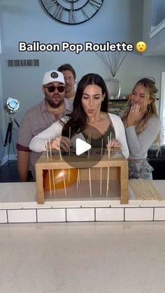 a group of people standing in front of a cake with candles on top of it