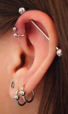 a woman with three piercings on her ear