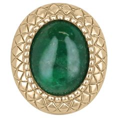 a green stone in a gold plated ring