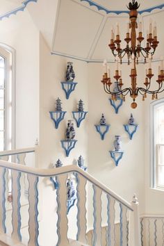 a chandelier hanging from the ceiling in a room with blue and white decor