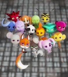 a bunch of small toy animals hanging from the ceiling with eyes and ears on them