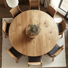 an overhead view of a wooden table and chairs