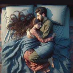 a man and woman laying in bed with their arms around each other as they cuddle