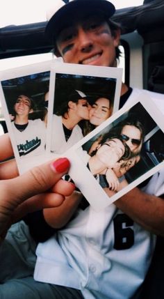 a person holding up four polaroid photos in their hands while sitting in a car