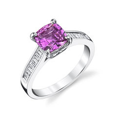 a white gold ring with a pink diamond and baguettes on the sides, set in