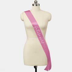 a female mannequin with a pink sash on it